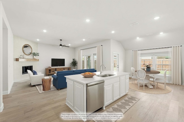 kitchen with dishwasher, white cabinetry, ceiling fan, light hardwood / wood-style flooring, and a kitchen island with sink