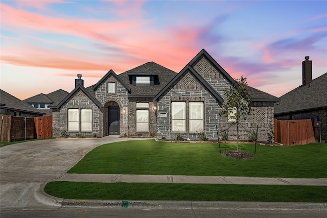 french country home featuring a lawn