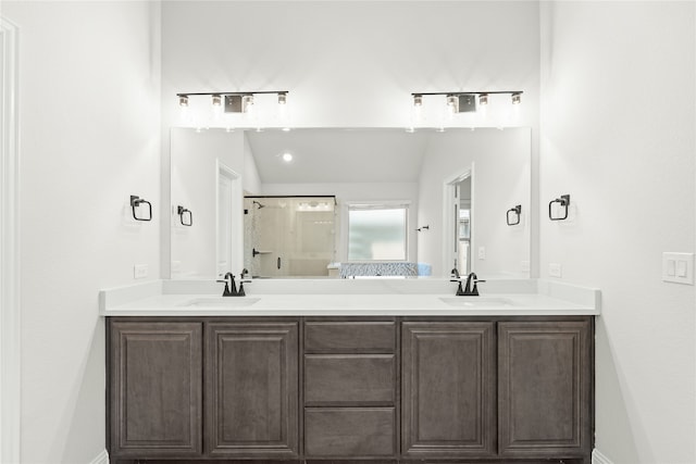 bathroom with vanity, an enclosed shower, and lofted ceiling