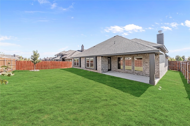 rear view of property with a patio area and a lawn