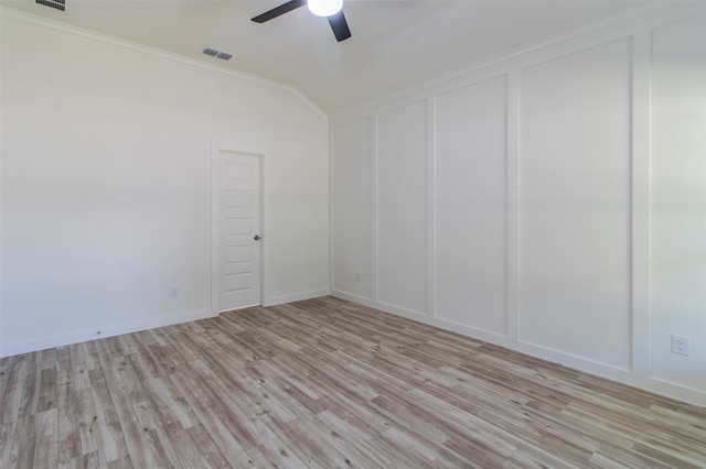 empty room with ceiling fan, crown molding, light hardwood / wood-style flooring, and lofted ceiling