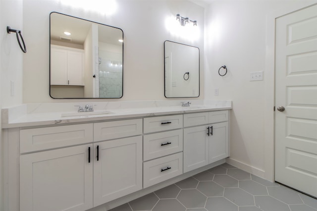 bathroom with double vanity and tile patterned floors