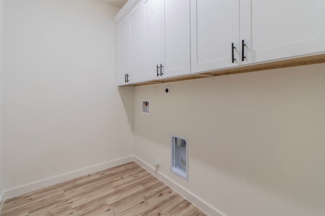 laundry area with light hardwood / wood-style flooring, hookup for a gas dryer, cabinets, hookup for an electric dryer, and washer hookup