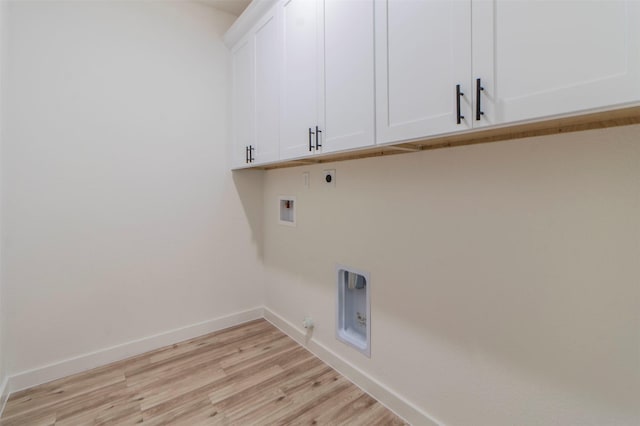 laundry room featuring gas dryer hookup, hookup for a washing machine, light wood-style floors, cabinet space, and electric dryer hookup