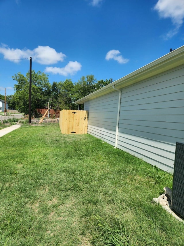 view of yard with cooling unit and fence