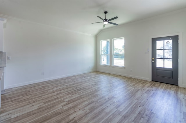 unfurnished living room featuring lofted ceiling, crown molding, light wood-type flooring, and ceiling fan