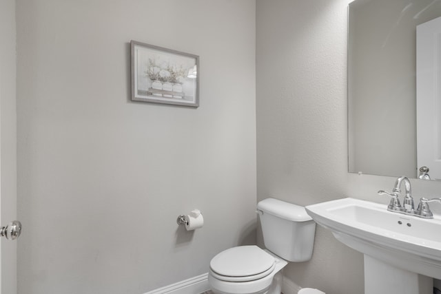 bathroom featuring sink and toilet