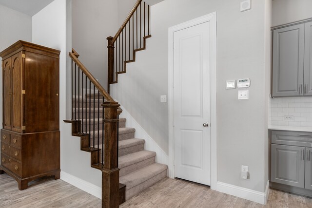 stairs featuring hardwood / wood-style flooring