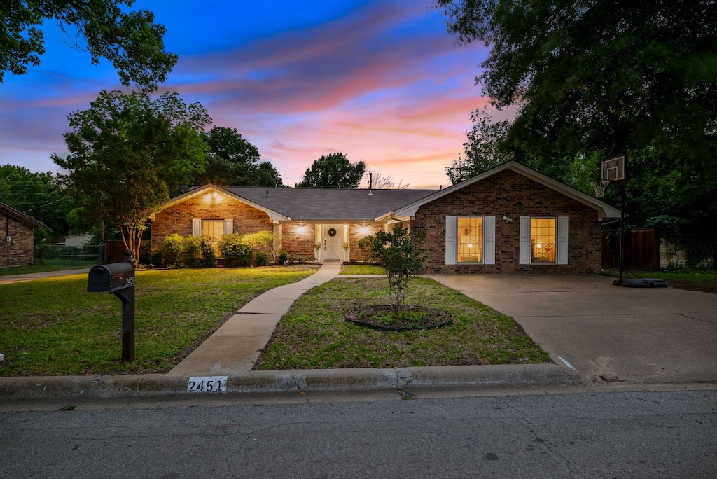 ranch-style home with a yard