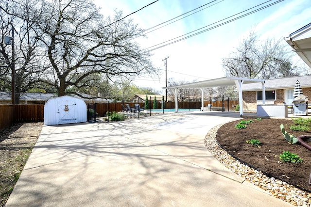 view of patio / terrace with a swimming pool and a storage unit