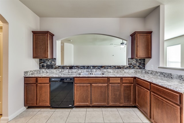 kitchen featuring sink, ceiling fan, light tile patterned floors, black dishwasher, and tasteful backsplash