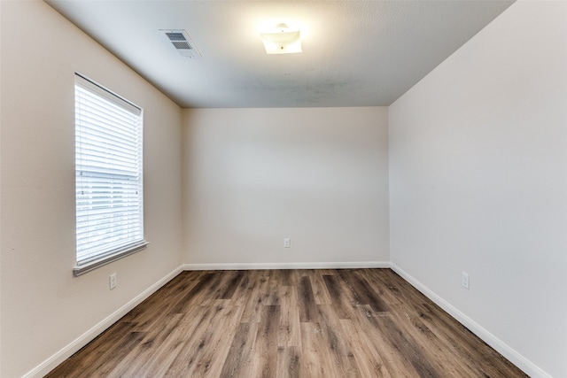 empty room with dark wood-type flooring