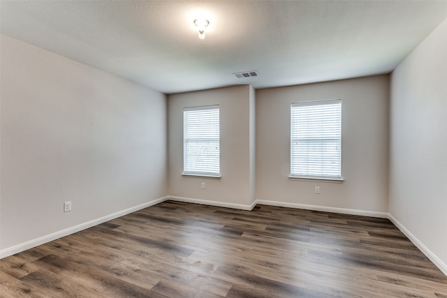 spare room with dark hardwood / wood-style floors