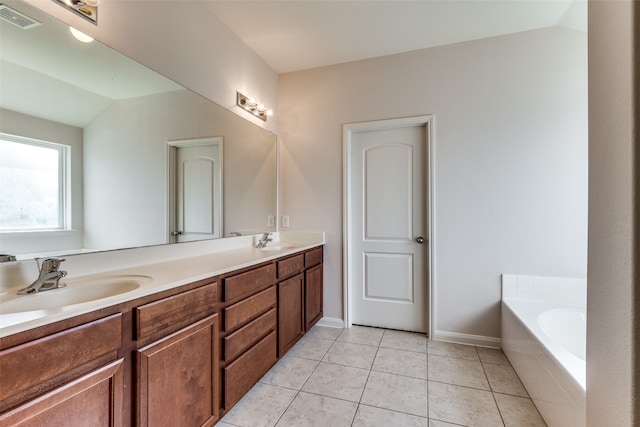 bathroom with vanity, tiled bath, tile patterned floors, and lofted ceiling