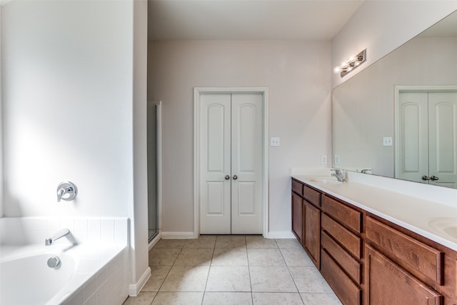 bathroom featuring tile patterned floors, vanity, and plus walk in shower