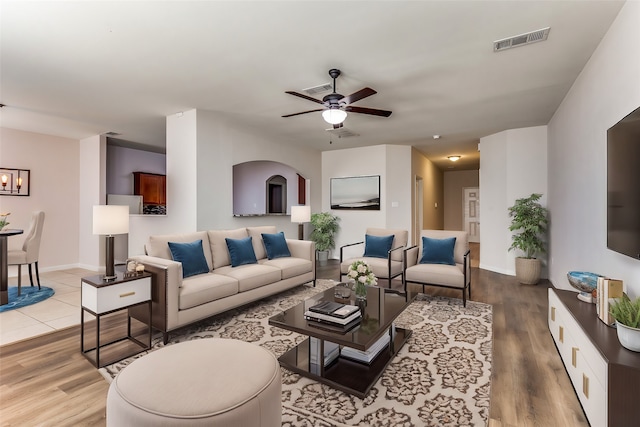 living room featuring ceiling fan and light hardwood / wood-style floors