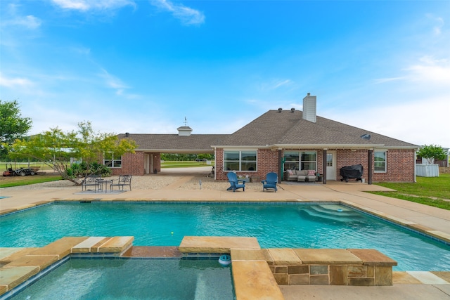 view of swimming pool featuring a grill, an outdoor living space, and a patio area