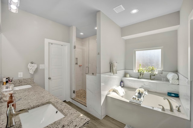 bathroom with vanity, hardwood / wood-style floors, and shower with separate bathtub