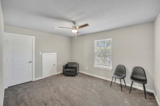 sitting room featuring carpet and ceiling fan