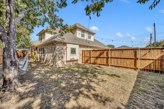 back of property featuring a lawn