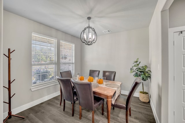 dining room featuring a chandelier and dark hardwood / wood-style flooring