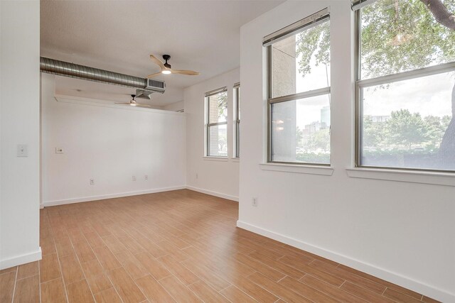 unfurnished room with ceiling fan and light hardwood / wood-style flooring