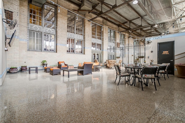 dining area with a towering ceiling