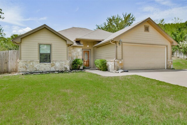 ranch-style house featuring a garage and a front yard