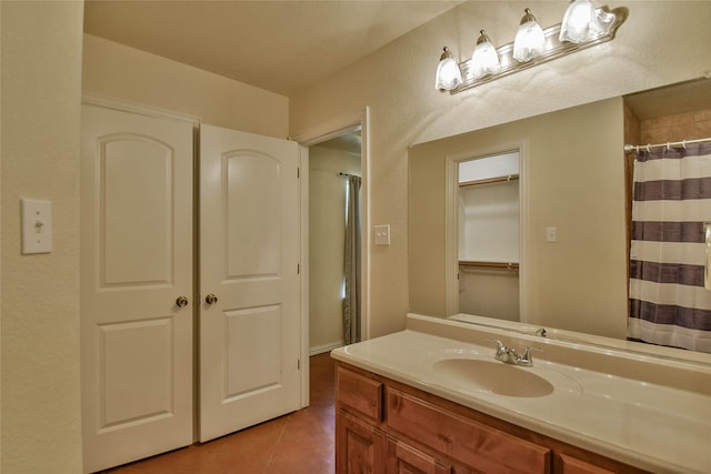 bathroom featuring tile patterned flooring and vanity