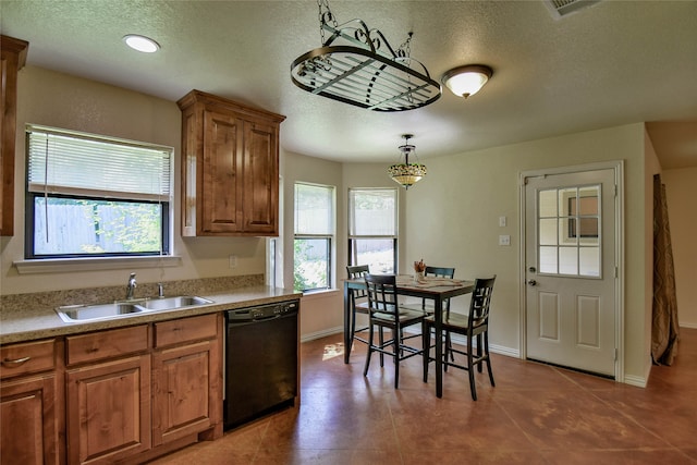 kitchen with a textured ceiling, a healthy amount of sunlight, sink, and black dishwasher