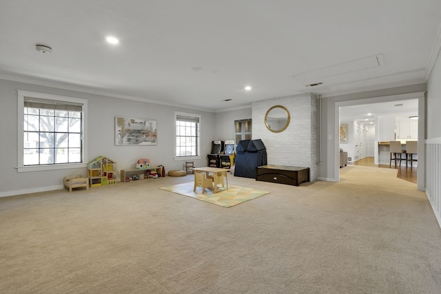 unfurnished living room with crown molding, a healthy amount of sunlight, and light colored carpet