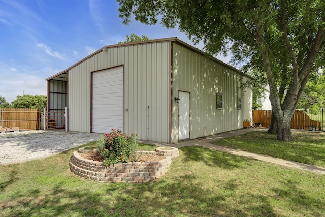 view of outbuilding featuring a garage and a lawn