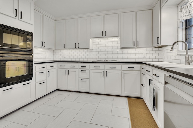 kitchen featuring white cabinetry, backsplash, black appliances, and light tile patterned floors