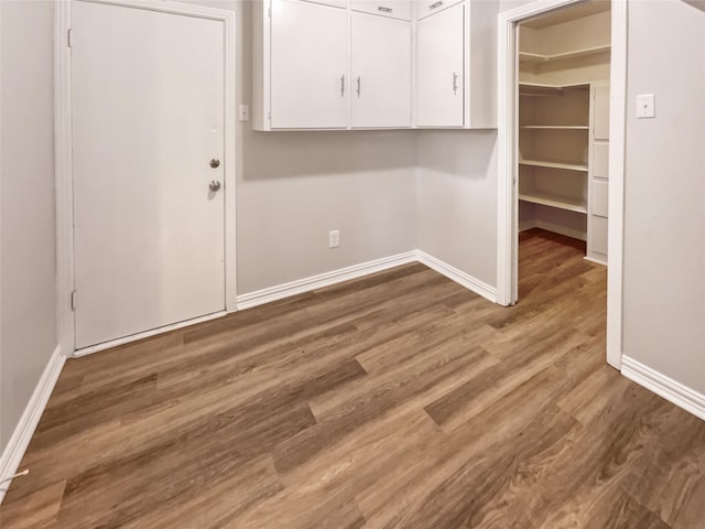 clothes washing area with wood-type flooring