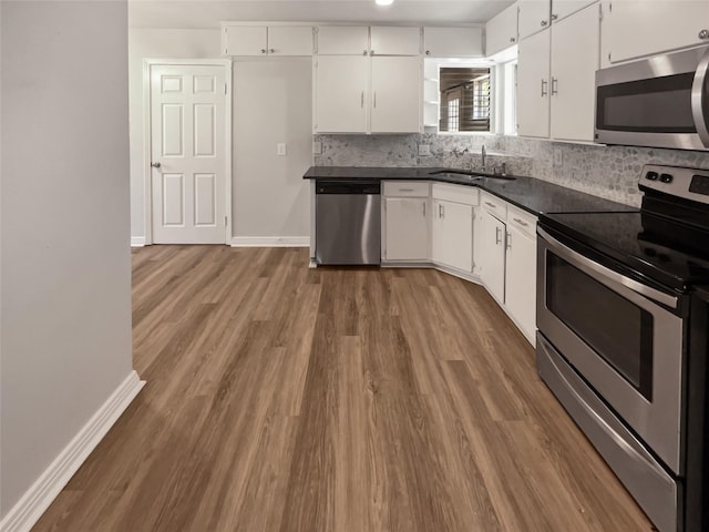 kitchen featuring dark wood-type flooring, sink, white cabinets, and stainless steel appliances