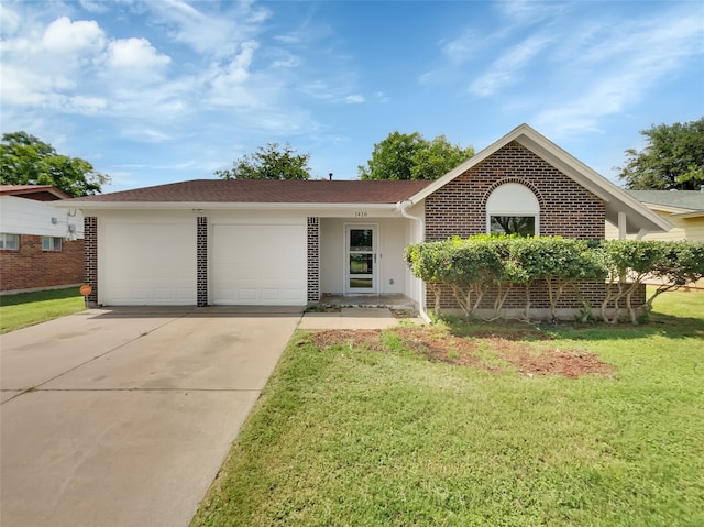 single story home with a front yard and a garage