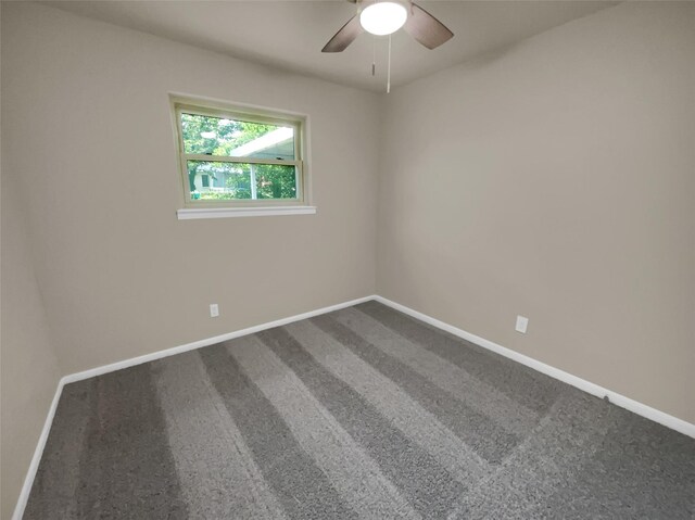 unfurnished room with ceiling fan and carpet