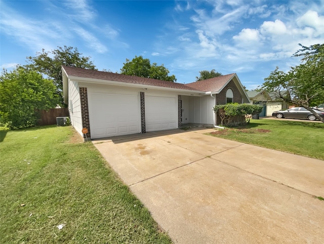 ranch-style home with a front lawn, a garage, and central air condition unit