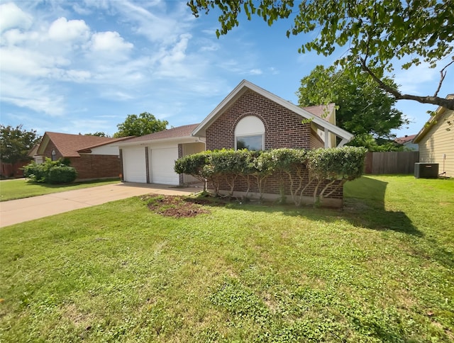 view of front facade with a garage, a front yard, and central air condition unit