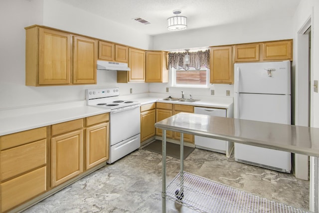 kitchen featuring white appliances, visible vents, a sink, light countertops, and under cabinet range hood