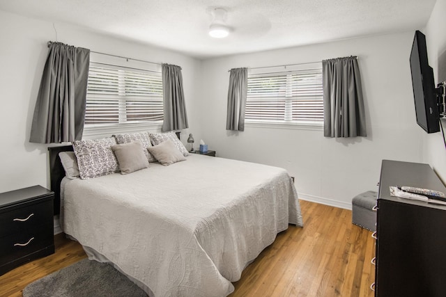 bedroom featuring light wood-style floors and baseboards