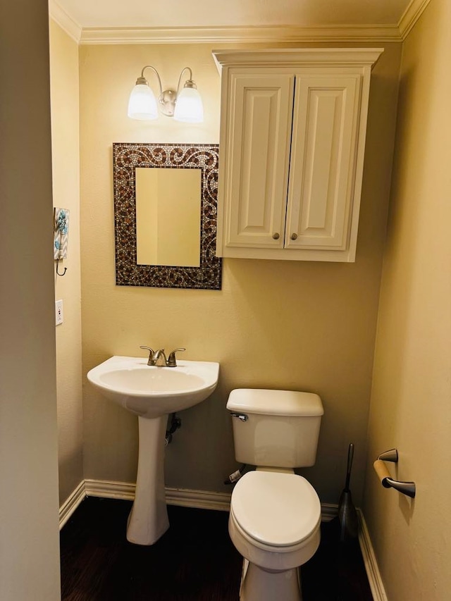 bathroom with toilet and crown molding