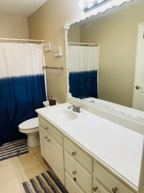 bathroom with tile patterned flooring, vanity, and toilet