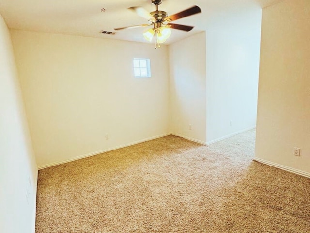 carpeted spare room with ceiling fan