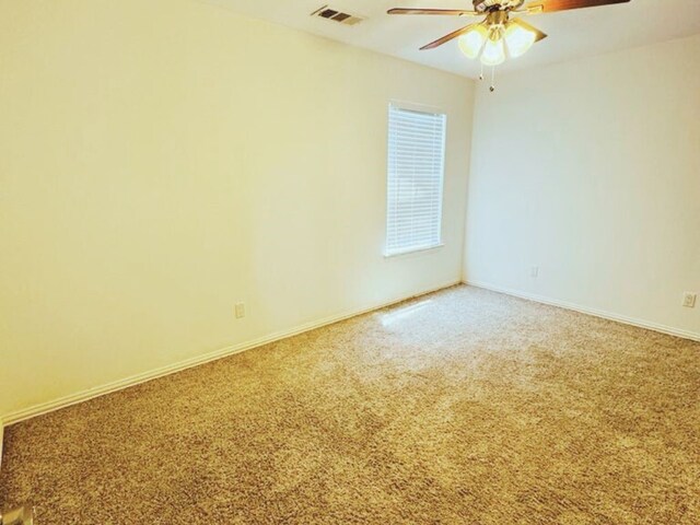 spare room with ceiling fan and carpet floors