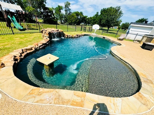 view of pool featuring pool water feature and a lawn