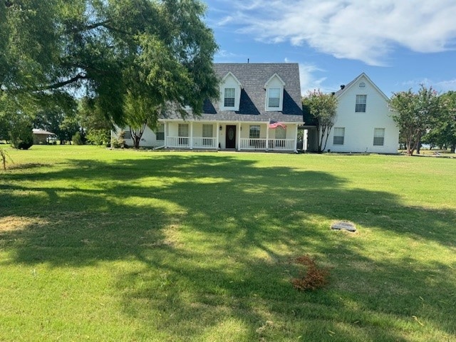 view of front of property with a front yard and a porch