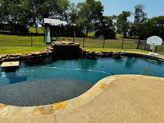 view of pool featuring a lawn