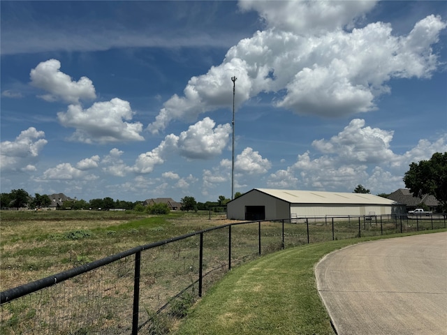 view of yard with a rural view and an outdoor structure