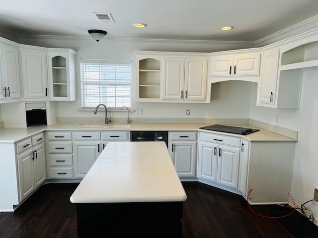 kitchen with white cabinets, black appliances, sink, a kitchen island, and dark hardwood / wood-style flooring